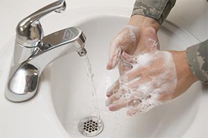 Washing hands with soap and water - reusable image from media.defense.gov zu607-001