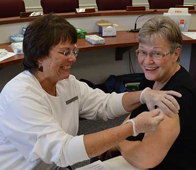 Board of Elections Administrator Marge McCabe gets her flu shot