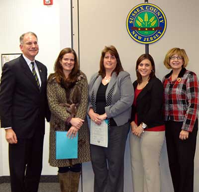 Freeholder Dennis Mudrick, Mrs. Campbell from Dale's Market, two representatives from First Hope Bank and Carol Novrit