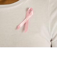 Pink ribbon pinned on blouse