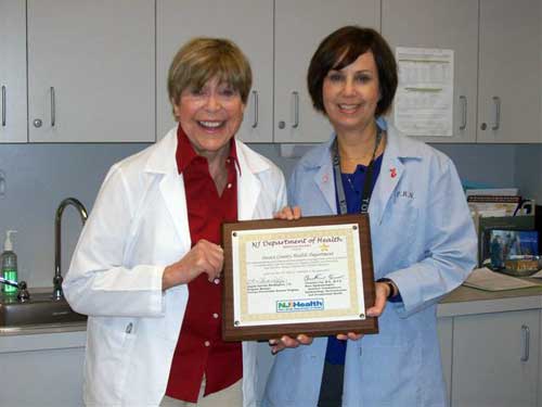 Sussex County Office of Public Health Nursing nurses Betty Martin and Michele Roth accept the New Jersey Department of Health Service Award